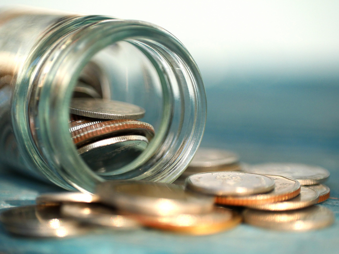 A lot of coins in a jar in the concept of saving money and finance.Selection focus.